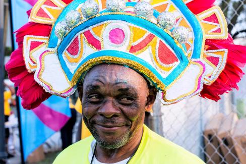 Junkanoo members in the streets with their costumes posing for the camera.